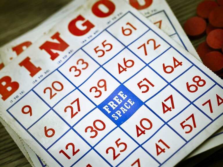 Printed bingo cards with numbers marked off